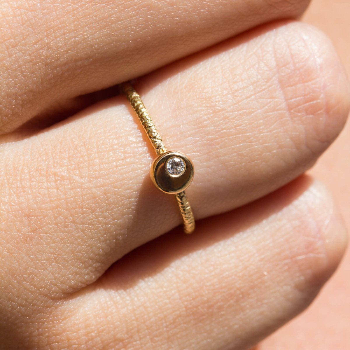 Bague artisanale en or ornée d'un diamant.