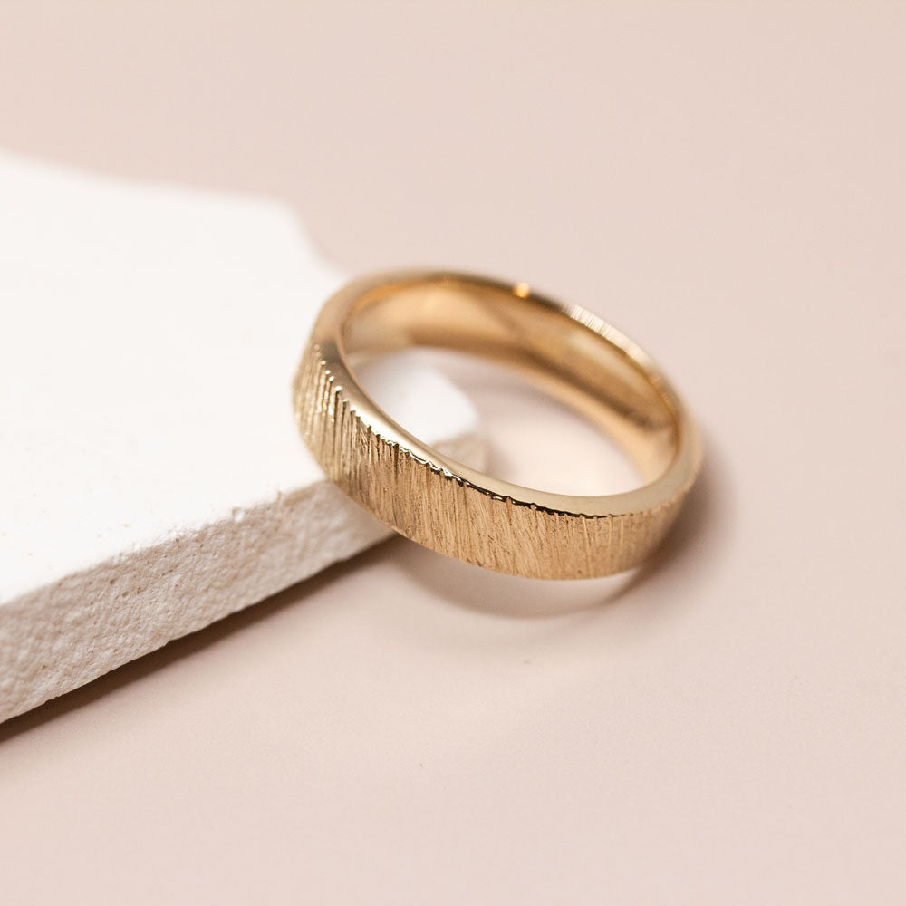 Alliance en or rose texturée.