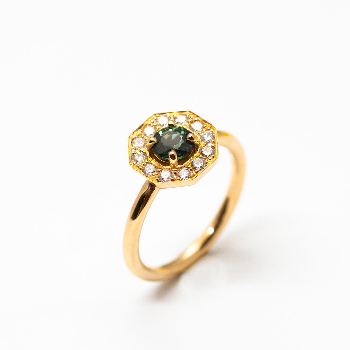 Pièce unique - Bague de demande Art Déco géométrique Leone XL portée, sertie d'un saphir Teal bleu-vert entouré de 16 diamants de synthèse en or rose-champagne recyclé 18 carats. Disponible taille 53, réalisée à Paris dans notre atelier de joaillerie