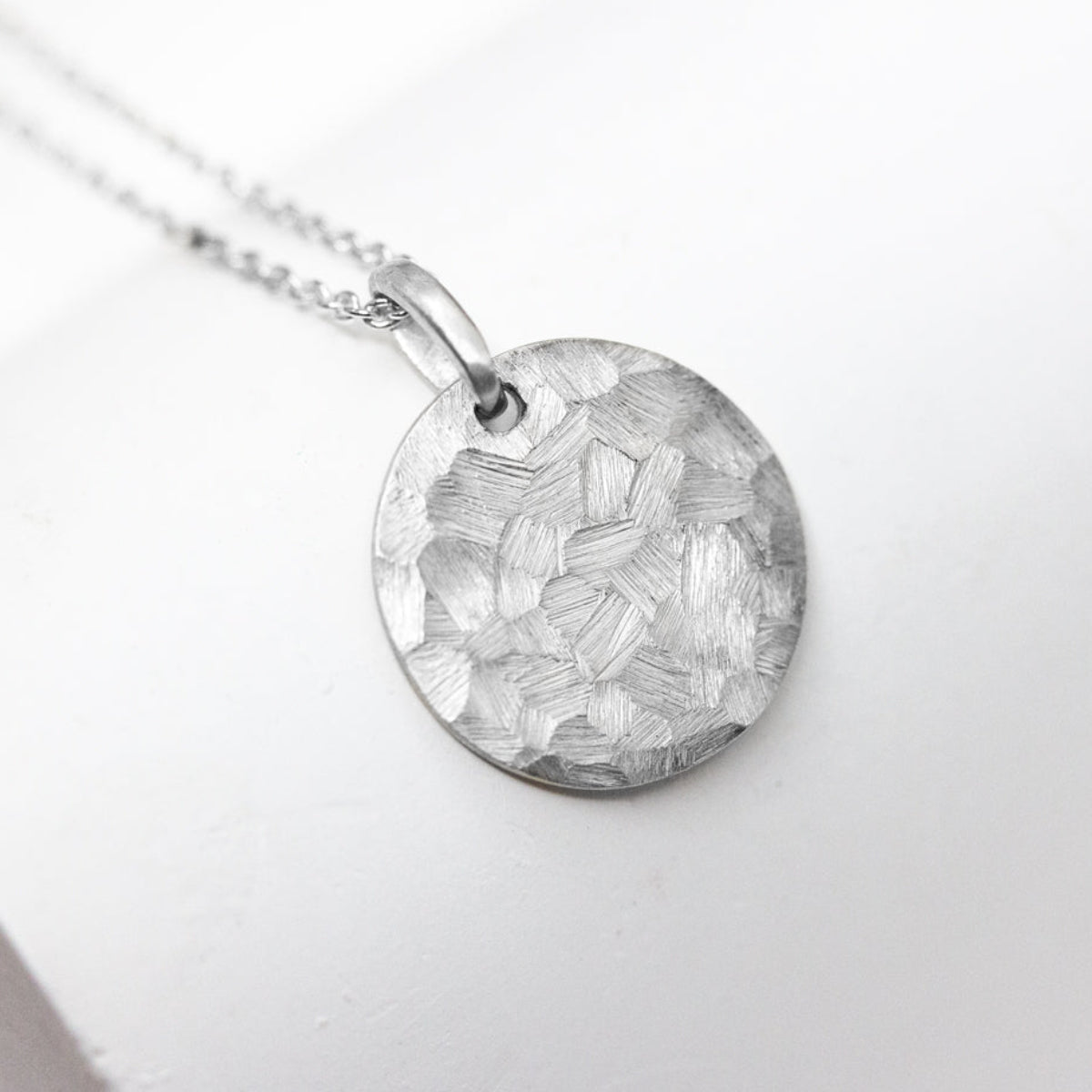 Médaille artisanale originale à offrir, texture brossée Staël fabriquée à la main à Paris dans notre atelier