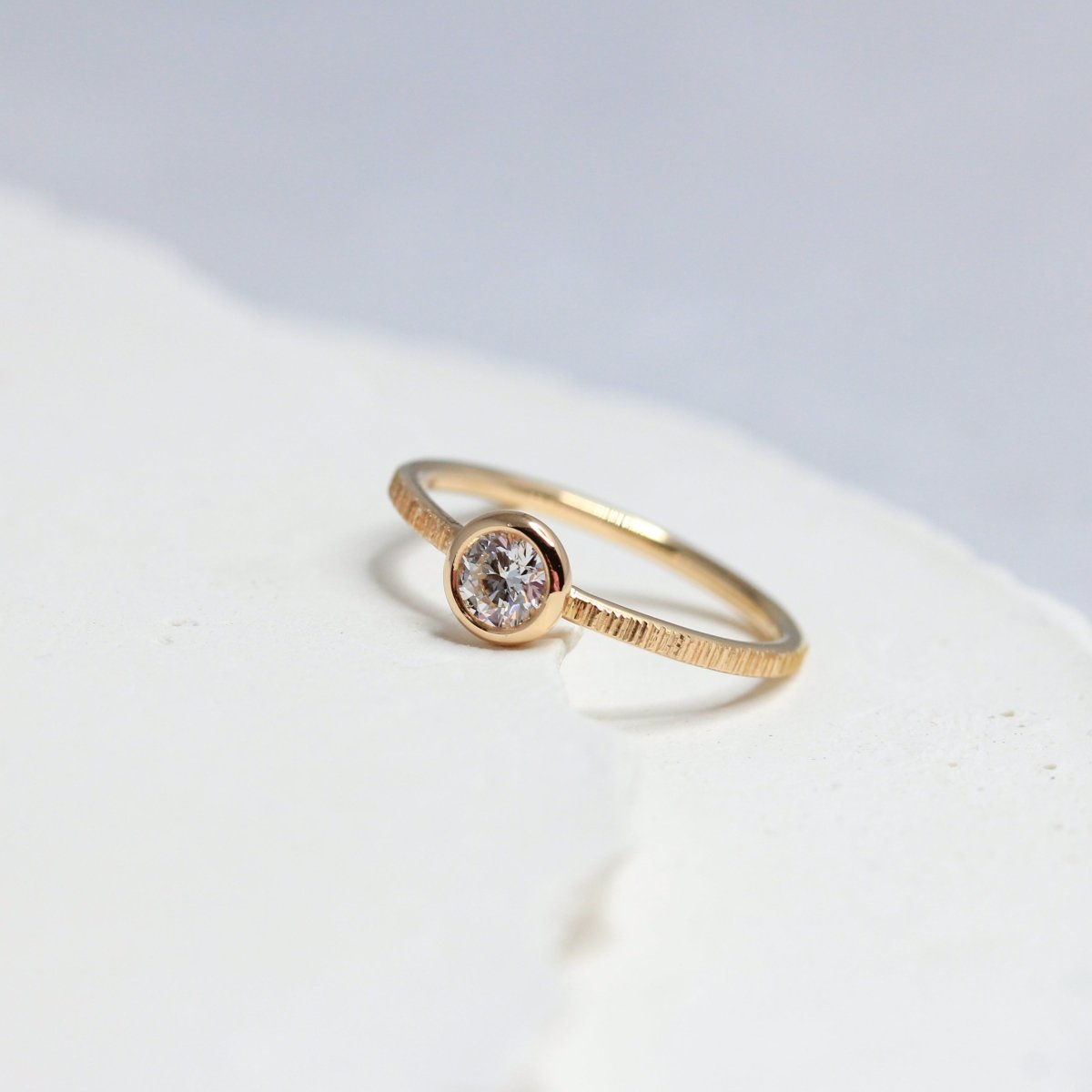 Bague de fiançailles pour femme ou homme en or rose-champagne, ornée d'un diamant.