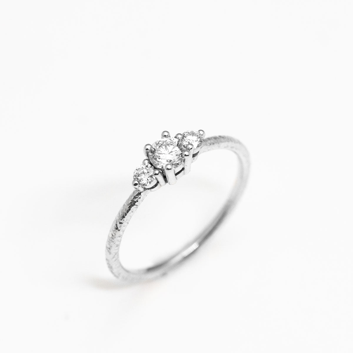 Bague de fiançailles épaulée femme Soleine jonc 1,5 et 3 diamants de synthèse réalisée à la main en or blanc recyclé 18 carats et crédit Fairmined