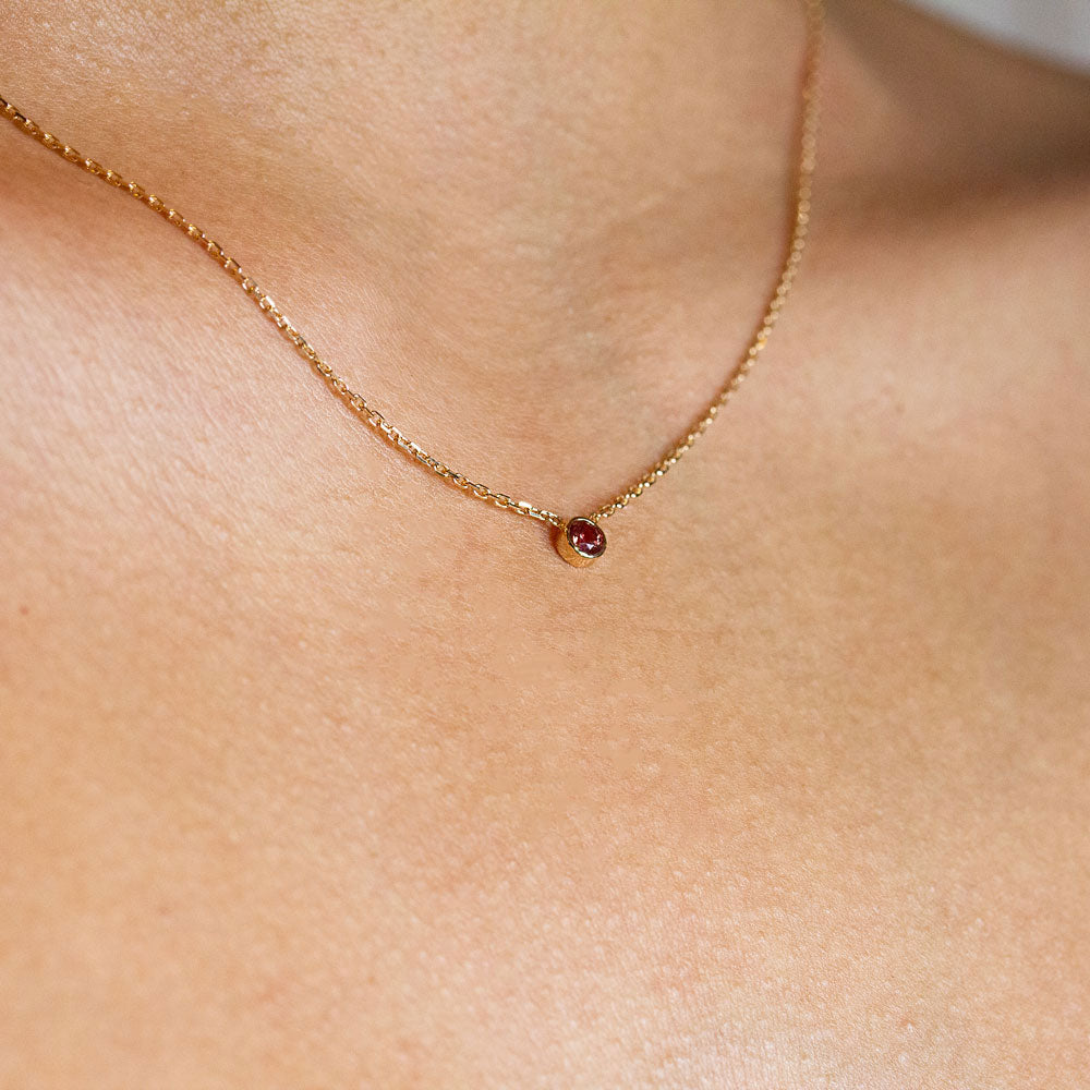 Un collier original en or éthique et un saphir rouge orangé