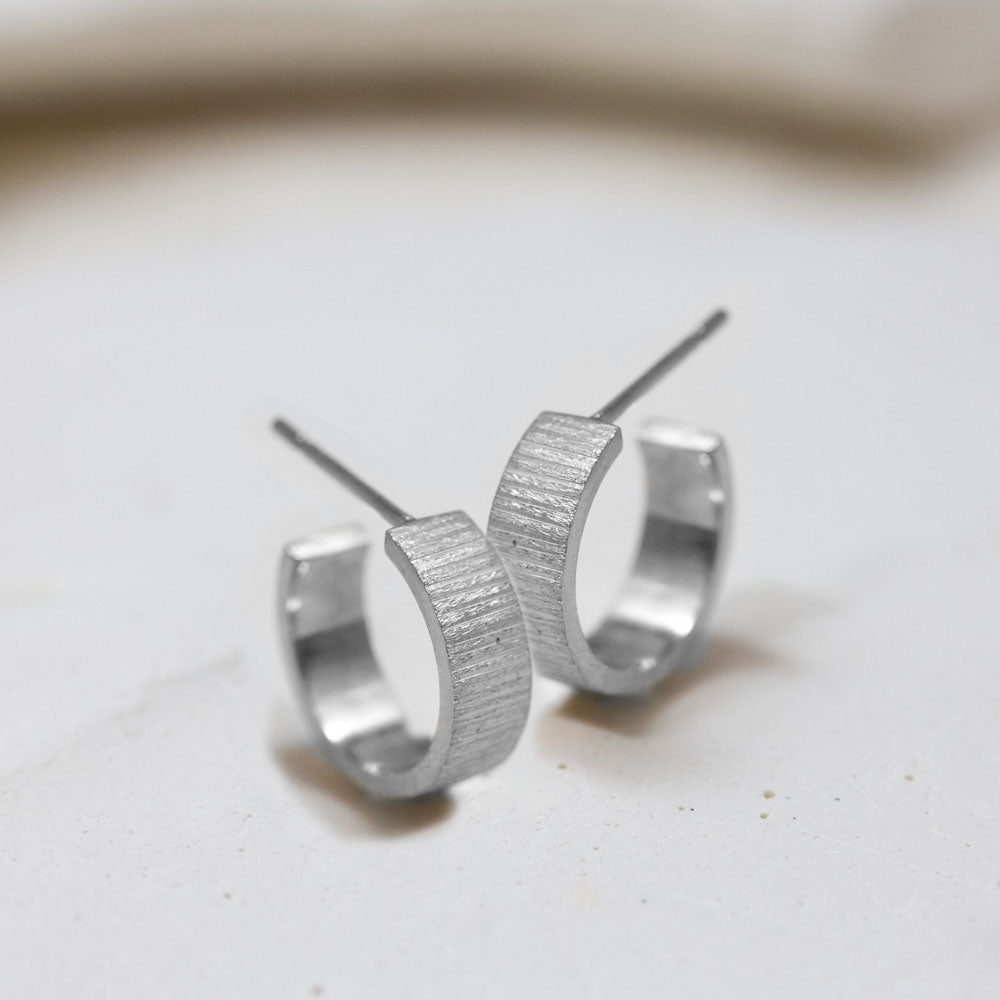 Créoles en or blanc Fairmined réalisées dans un atelier de joaillerie.