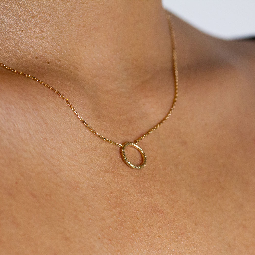 Collier cercle texturé en or éthique 18 carats Fairmined réalisé dans un atelier de joaillerie.