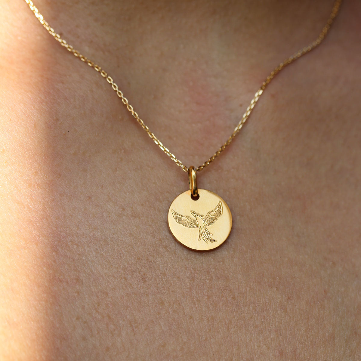 Médaille en or gravée d'un phoenix,en or Fairmined.