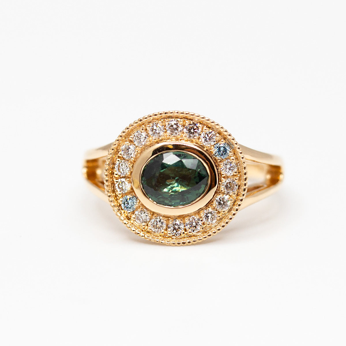 Sur-mesure : Bague entourage vale style chevalière en or jaune Fairmined 750/1000, sertie d'un saphir ovale entouré de diamants de synthèse, serti millegrain au charme ancien
Conception de bijoux sur-mesure à paris