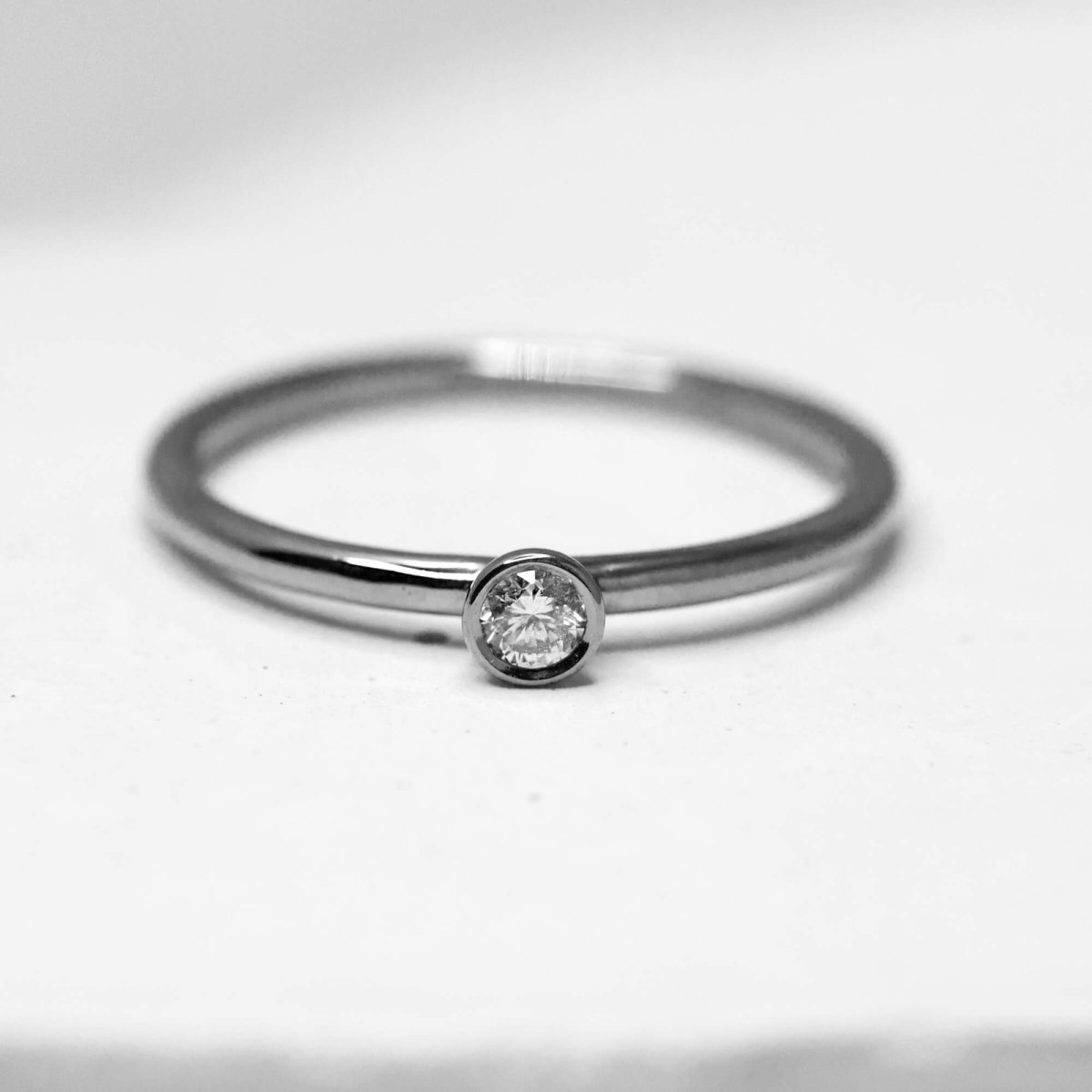 Bague fine ornée d'un diamant en or gris palladié 18 carats Fairmined. Joaillerie éthique et artisanale