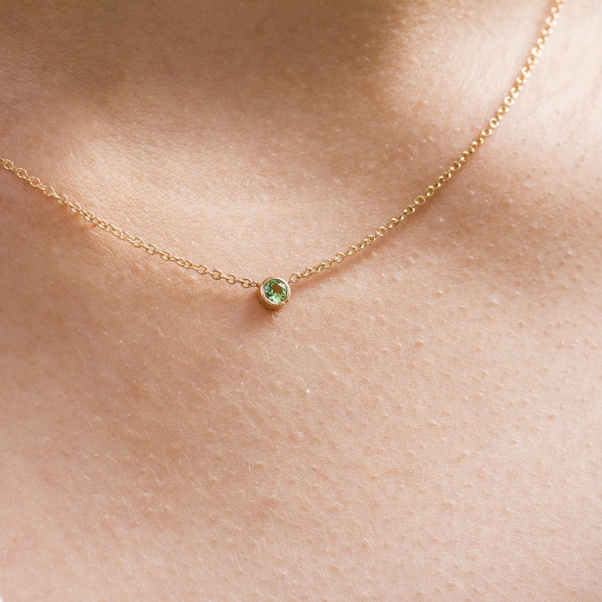 Collier original en or rose 18 carats Fairmined orné d'un grenat vert au centre.